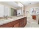 Bathroom with double sinks, granite countertops, and updated cabinetry at 3818 Bordeaux Dr, Punta Gorda, FL 33950