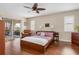 Main bedroom with a king-size bed, wood floors and sliding glass doors leading to the balcony at 3818 Bordeaux Dr, Punta Gorda, FL 33950