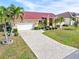 Single-story home with red tile roof, white garage door, and paver driveway at 3818 Bordeaux Dr, Punta Gorda, FL 33950