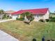 Single-story home with red tile roof and landscaped yard at 3818 Bordeaux Dr, Punta Gorda, FL 33950