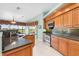 Kitchen with wood cabinets, granite countertops, and stainless steel appliances at 3818 Bordeaux Dr, Punta Gorda, FL 33950