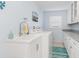 Bright laundry room with white cabinets, granite countertops, and a utility sink at 3818 Bordeaux Dr, Punta Gorda, FL 33950