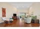 Living room with wood floors, mid century chair, and view of golf course at 3818 Bordeaux Dr, Punta Gorda, FL 33950