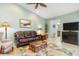 Bright living room with leather sofa and access to kitchen at 3818 Bordeaux Dr, Punta Gorda, FL 33950