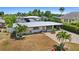 An aerial view of a single story home with a metal roof and a large backyard at 429 W Ann St, Punta Gorda, FL 33950