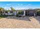 Single story home with light colored walls, metal roof, and a landscaped front yard at 429 W Ann St, Punta Gorda, FL 33950