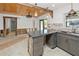 Modern kitchen with dark wood cabinets, granite countertops, and exposed beams at 429 W Ann St, Punta Gorda, FL 33950