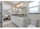 Bright bathroom featuring dual sinks, granite countertops, and modern fixtures at 6356 Opa Locka Ln, North Port, FL 34291