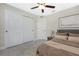 Well-lit bedroom featuring closet with sliding door, fan, and neutral decor at 6356 Opa Locka Ln, North Port, FL 34291