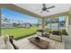 Relax on this screened lanai with comfortable seating and views of the expansive backyard at 6356 Opa Locka Ln, North Port, FL 34291