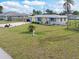 Cute ranch home with a large front yard, newly painted exterior and a spacious driveway at 817 E 6Th St, Englewood, FL 34223