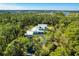 House nestled in a wooded area with a long driveway at 340 N River Rd, Venice, FL 34293