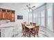 Bright breakfast nook with wood table and chairs, adjacent to kitchen at 340 N River Rd, Venice, FL 34293