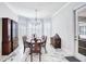 Bright dining room features a marble floor, a chandelier, and built-in cabinetry at 340 N River Rd, Venice, FL 34293