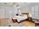 Bright main bedroom with hardwood floors and en-suite bathroom at 340 N River Rd, Venice, FL 34293