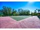 Well-maintained tennis court with surrounding trees at 340 N River Rd, Venice, FL 34293