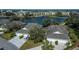 Aerial view of two-story home with three-car garage, water view, and community amenities at 1013 Live Oak Cir # 13, Port Charlotte, FL 33948