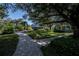 Brick pathways meander through a lush landscape with community buildings at 1013 Live Oak Cir # 13, Port Charlotte, FL 33948