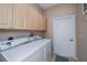 Laundry room with washer, dryer, and ample cabinets at 1013 Live Oak Cir # 13, Port Charlotte, FL 33948