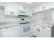 Modern white kitchen with new appliances and marble counters at 1515 Forrest Nelson Blvd # D207, Port Charlotte, FL 33952