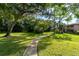 Landscaped pathway meanders through lush green space at 1515 Forrest Nelson Blvd # D207, Port Charlotte, FL 33952