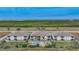 Aerial view of three-story townhouses with a shared pool at 17094 Acapulco Rd # 313, Punta Gorda, FL 33955