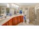 Bathroom with double vanity, large mirror, and shower at 17094 Acapulco Rd # 313, Punta Gorda, FL 33955