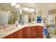 Double vanity, corner sink, and wood cabinets at 17094 Acapulco Rd # 313, Punta Gorda, FL 33955
