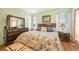 King-size bed, wood furniture, and beach themed decor at 17094 Acapulco Rd # 313, Punta Gorda, FL 33955