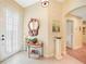Bright entryway with a unique mirror and coastal-themed decor at 17094 Acapulco Rd # 313, Punta Gorda, FL 33955