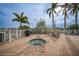 Community hot tub with patio furniture and palm trees at 17094 Acapulco Rd # 313, Punta Gorda, FL 33955