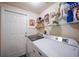 Laundry room with washer, dryer, and storage shelves at 17094 Acapulco Rd # 313, Punta Gorda, FL 33955