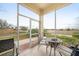 Screened porch with patio furniture and backyard view at 17094 Acapulco Rd # 313, Punta Gorda, FL 33955