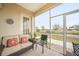 Cozy screened porch with comfortable seating and landscaping views at 17094 Acapulco Rd # 313, Punta Gorda, FL 33955