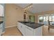 Kitchen island with sink and dishwasher, view to backyard pool at 18646 Kerrville Cir, Port Charlotte, FL 33948