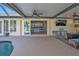 Covered patio overlooking pool, kitchen and TV at 18646 Kerrville Cir, Port Charlotte, FL 33948