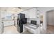 Modern kitchen with granite countertops, white cabinets, and built-in desk at 22278 Vick St # A100, Punta Gorda, FL 33980