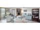 Bright living room with fireplace, comfy seating, and a bookcase at 22278 Vick St # A100, Punta Gorda, FL 33980