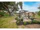 Large backyard featuring a gazebo, patio, and mature trees at 22481 Vale Ave, Punta Gorda, FL 33980