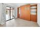Bedroom with wood-look floors, built-ins and patio access at 22481 Vale Ave, Punta Gorda, FL 33980