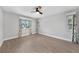 Bright bedroom with wood-look tile floors and floral curtains at 22481 Vale Ave, Punta Gorda, FL 33980