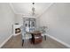 Bright dining area with a glass-top table and corner fireplace at 22481 Vale Ave, Punta Gorda, FL 33980