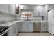 Modern kitchen with gray cabinets, marble countertops, and stainless steel appliances at 22481 Vale Ave, Punta Gorda, FL 33980