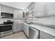 Modern kitchen with gray cabinets, marble countertops, and stainless steel appliances at 22481 Vale Ave, Punta Gorda, FL 33980