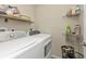 Laundry room with washer, dryer, and shelving at 22481 Vale Ave, Punta Gorda, FL 33980