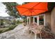 Relaxing patio with seating area and orange umbrella at 22481 Vale Ave, Punta Gorda, FL 33980
