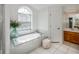Relaxing bathroom with a large soaking tub and arch window at 23176 Lindale Ave, Port Charlotte, FL 33954