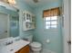 Small half bathroom with toilet and sink at 23176 Lindale Ave, Port Charlotte, FL 33954