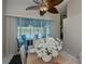 Elegant dining room with pool view and stunning floral centerpiece at 23176 Lindale Ave, Port Charlotte, FL 33954