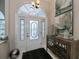 Elegant entryway with stained glass door and console table at 23176 Lindale Ave, Port Charlotte, FL 33954